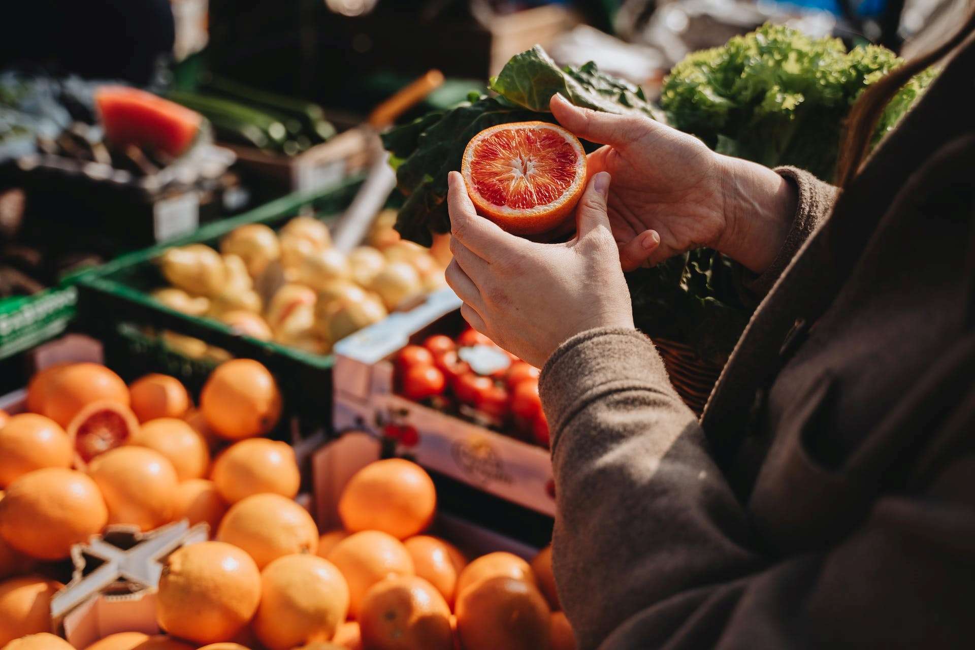 a person holding a fresh sliced orange